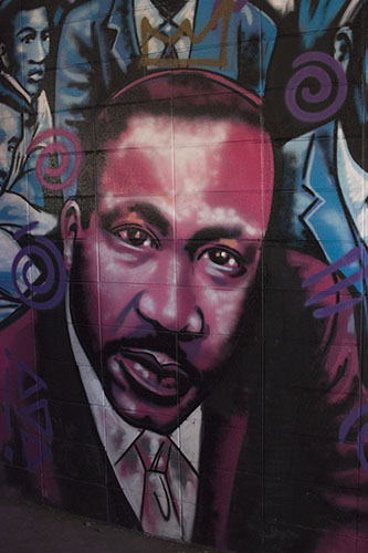 A painting of Dr. Martin Luther King from the #ExhibitBe installation on the Westbank. One of the founder of the project, Brandan "BMike" Odums, also spoke at Monday's commemoration. (Zach Brien, UptownMessenger.com)