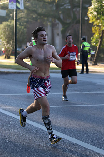Harrison Donnell of Slidell crosses Calhoun street in his half marathon. (Zach Brien, UptownMessenger.com)