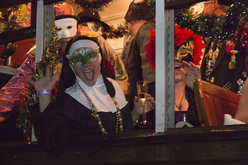 Masks on and drinks in hand, the Phellows packed the streetcar as it headed down St. Charles. (Zach Brien, UptownMessenger.com)
