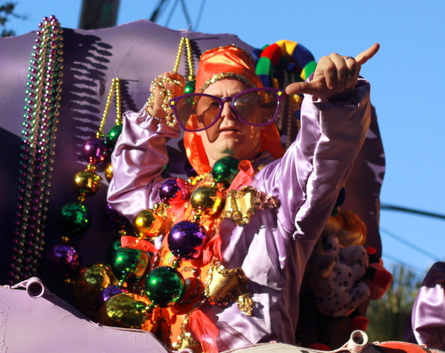 A rider prepares to toss beads from the Krewe of Alla "Victory" float. (Robert Morris, UptownMessenger.com)