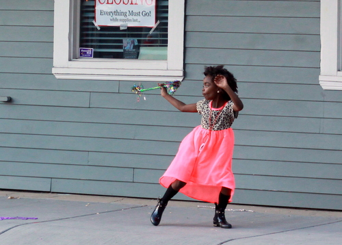 A girl dances with a baton as the Mystic Krewe of Femme Fatale passes on Magazine Street. (Robert Morris, UptownMessenger.com)