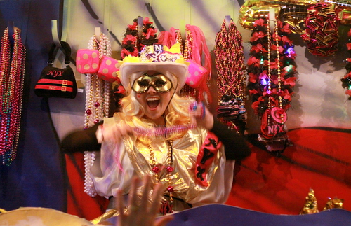 A rider in the Mystic Krewe of Nyx displays throws to the Magazine Street crowd. (Robert Morris, UptownMessenger.com)