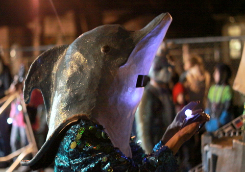 A Krewe of Kolossos dolphin takes a selfie during the Muses parade. (Robert Morris, UptownMessenger.com)