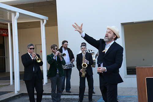 Actor John C. Reily throws Bacchus doubloons to the audience.