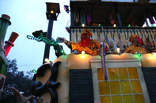 A rider on the "Bacchatality" float throws beads to the crowd. (Zach Brien, UptownMessenger.com)