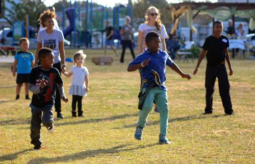 Children play dodgeball during the Freret Get-Together at Evans Park in December 2014. The event was hosted by the Evans Park Booster Club, with activities organized by Eric and Claudean Capers of Anytime Fitness. (Photo by Liz Jurey, courtesy of Freret Neighborhood Center)