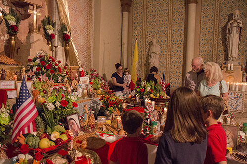 People observe the elaborate altar at St. Stephen's church. (Zach Brien, UptownMessenger.com)