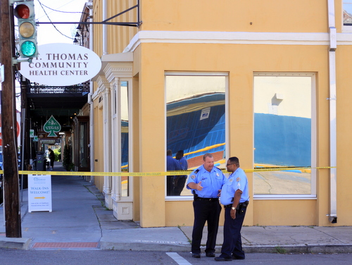 A NOPD lieutenant and sergeant confer at the corner of St. Andrew and Magazine, following a shooting in April 2015. (Robert Morris, UptownMessenger.com)