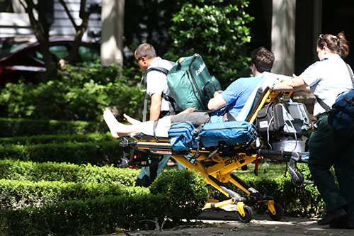 Paramedics take a man on a stretcher for treatment after a fire at 5940 Freret. (Zach Brien, UptownMessenger.com)
