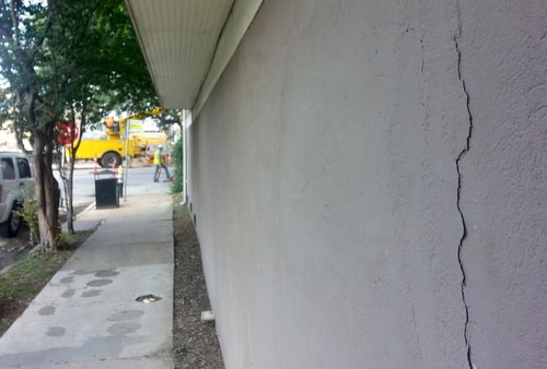 A crack is visible in a foundation that attorney Michael Whitaker says is only 9 years old in the 2500 block of Napoleon Avenue. (Robert Morris, UptownMessenger.com)