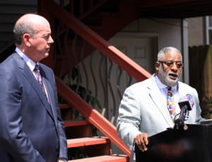 Attorney Michael Whitaker (left) listens as the Rev. Tom Watson describes damage to Watson Memorial Teaching Ministries on Napoleon Avenue during a news conference Wednesday morning. (Robert Morris, UptownMessenger.com)
