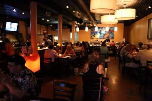 Attendees of the Maple Street Dishcrawl in July 2014 sample the fare at Little Tokyo, a Japanese restaurant in a space occupied by a college bar just a few years ago. (UptownMessenger.com file photo by Zach Brien)