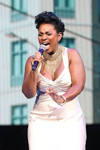 Stephanie Jordan sings during the Katrina 10 commemoration at the Smoothie King Center on Saturday. (Zach Brien, UptownMessenger.com)