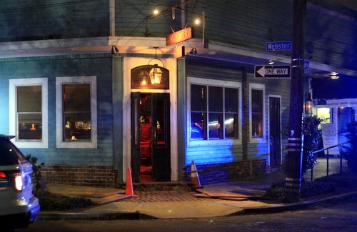 Police vehicles sit outside Monkey Hill bar on Magazine Street after a robbery Monday night. (Robert Morris, UptownMessenger.com)