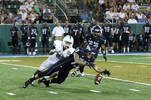 Tulane corner back Richard Allen falls on Maine receiver Justin Flores as Flores recovers his muffed punt. (Zach Brien, UptownMessenger.com)