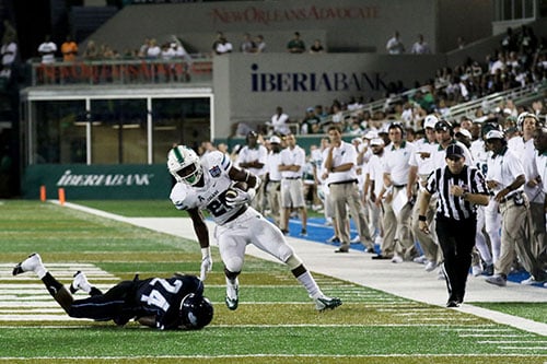 Tulane running back Dontrell Hilliard shoves off Maine cornerback Sinmisola Demuren on a run into the red zone. (Zach Brien, UptownMessenger.com)
