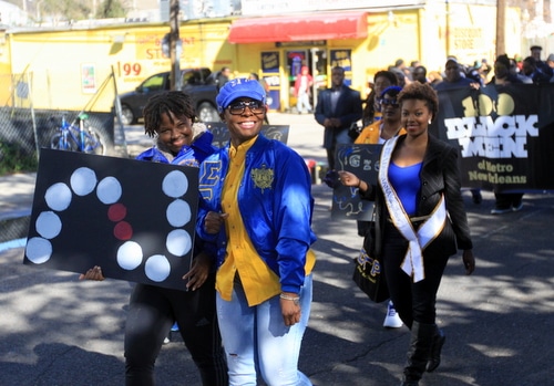 Sisters from the Sigma Gamma Rho sorority march through Central City. (Robert Morris, UptownMessenger.com)