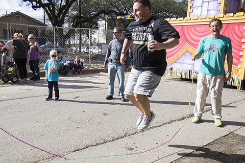 Jared Dubreuil, center, jumps rope with Jason Robertson, right, and his daughter Sophie, left, during a lull in the Krewe of King Arthur. King Arthur was one of four parades that rolled uptown on Sunday. (Zach Brien, UptownMessenger.com)