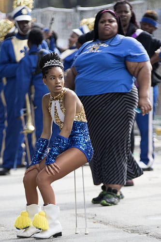 Baton girl from the Stella Wortley middle school marching band takes a rest during a lull in Krewe of King Arthur on Napoleon Avenue. King Arthur was one of four parades that rolled uptown on Sunday. (Zach Brien, UptownMessenger.com)