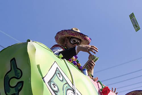 A rider on the "Business Opportunity" float in the Krewe of King Arthur tosses candy into the crowd along Napoleon avenue. King Arthur was one of four parades that rolled uptown on Sunday. (Zach Brien, UptownMessenger.com)