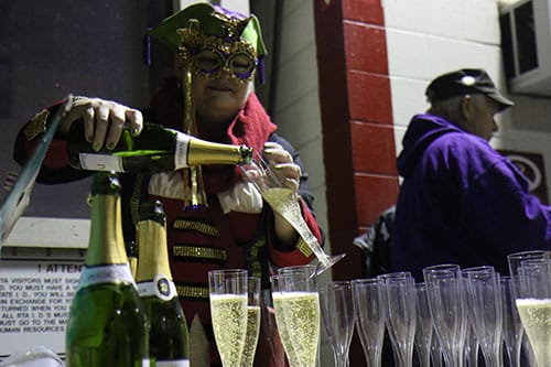 Sarah Hoffpauir pours glasses of champagne for the Phunny Phorty Phellows to welcome in Carnival season at the Willow Street streetcar barn. The event takes place on 12th night, 12 days after Christmas and is the first parade of Carnival season in New Orleans. (Zach Brien, UptownMessenger.com)