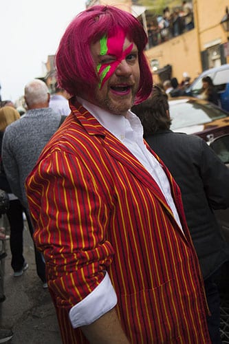 A man, dressed in his best David Bowie attire, posed for a photograph on a crowded St. Peter street. On Saturday, the Preservation Hall Jazz Band and members of Arcade Fire led a second line through the French Quarter in honor of musician David Bowie who died on January 10, 2016.