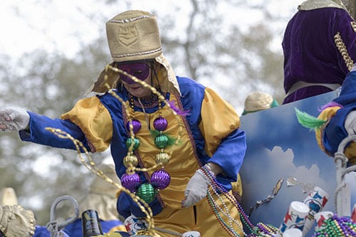 A rider on the "Connecticut , the _O_S_T_T__N State" float in the Krewe of Pontchartrain throws beads to an eager crowd on Napoleon avenue. The Krewe was one of five parades rolling Uptown on Saturday. (Zach Brien, UptownMessenger.com)