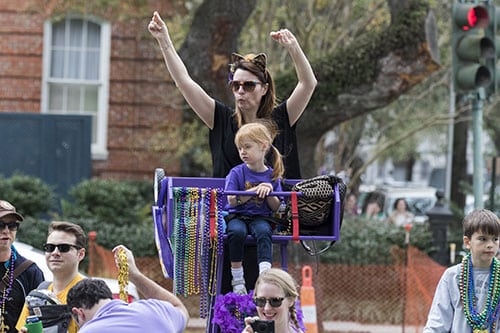 Rachelle Biondonlillo and Alla McKibben cheer for beads during the Krewe of Pontchartrain. The Krewe was one of five parades rolling Uptown on Saturday. (Zach Brien, UptownMessenger.com)