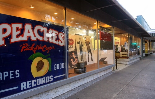 Peaches' massive sign fills the window at its temporary location next door to Top Drawer Antiques on Magazine Street. (Robert Morris, UptownMessenger.com)