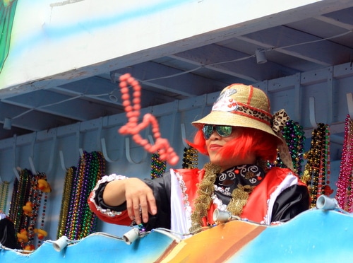 A rider throws beads as the Mystic Krewe of Femme Fatale rolled on St. Charles Avenue. (Robert Morris, UptownMessenger.com)