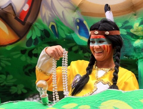 A rider laughs as she throws beads in the Krewe of Choctaw parade on Napoleon Avenue. (Robert Morris, UptownMessenger.com)