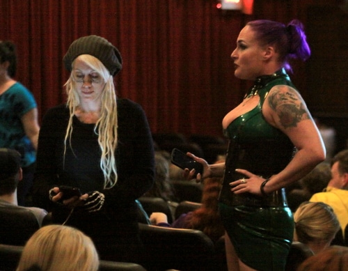 Two Bowie fans, Felina Dolly and Mistress Genevieve, wait for friends to arrive in their seats at the Prytania. (Robert Morris, UptownMessenger.com)