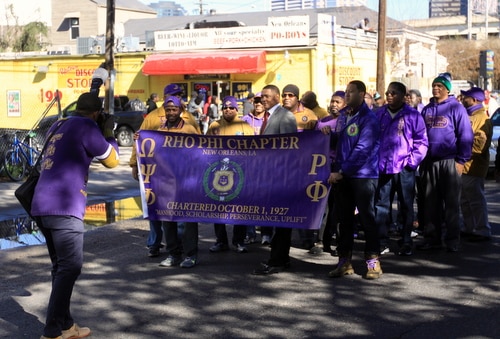 U.S. Rep. Cedric Richmond poses for a photo with a fraternity marching in the parade. (Robert Morris, UptownMessenger.com)