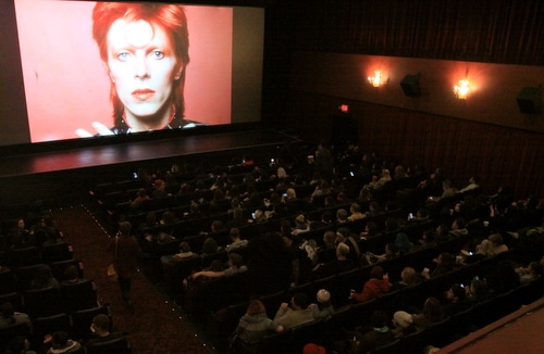 In his Aladdin Sane persona, an image of David Bowie looms over the full house at Prytania Theatre. (Robert Morris, UptownMessenger.com)