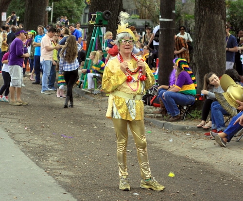 A costume reveler waits during a gap in the parade as the Mystic Krewe of Femme Fatale rolls on St. Charles Avenue. (Robert Morris, UptownMessenger.com)