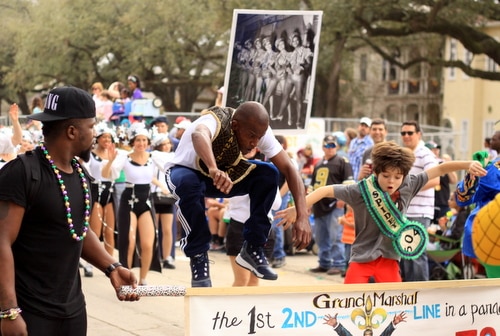Darryl "Dancing Man 504" Young and "Spidey 504" leap into the air at the head of the Krewe of Freret parade on Napoleon Avenue. (Robert Morris, UptownMessenger.com)