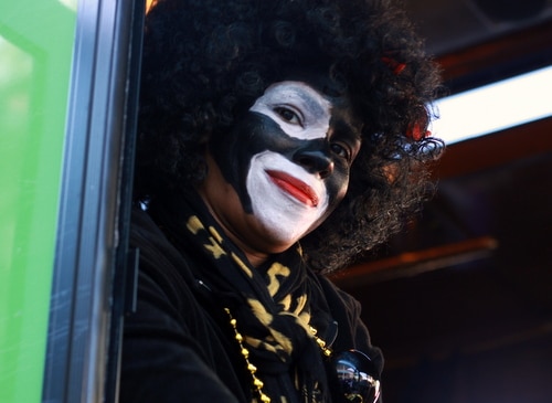 A member of the Krewe of Zulu smiles as she rides down St. Charles Avenue. (Robert Morris, UptownMessenger.com)