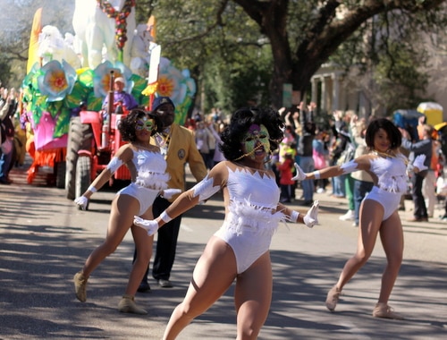 Dancers perform as the Bouef Gras float billows smoke behind them on St. Charles Avenue. (Robert Morris, UptownMessenger.com)