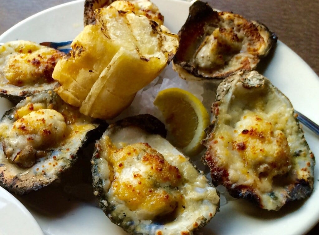 Charbroiled Oysters topped with Parmesan Pecorino Butter and Garlic Bread (Kristine Froeba)