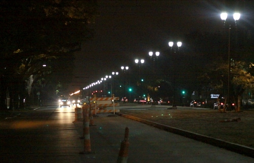 A row of new street lights and two lanes of traffic on Napoleon Avenue can be seen approaching Freret Street on the evening of March 31. Construction on this section will be finished in April, and on the entire avenue by the end of the year, officials said. (Robert Morris, UptownMessenger.com)