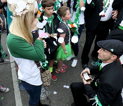 Brian McGing, right, proposes to Hillary Eyster, left, during the 66th annual Irish Channel St. Patrick's Day Parade on Saturday, March 12. (Zach Brien, UptownMessenger.com)