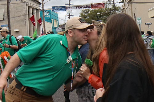 iAnne Balderson gets a kiss from a member of the Veterans of Foreign Wars on Magazine street during the 66th annual Irish Channel Parade on Saturday, March 12. (Zach Brien, UptownMessenger.com)