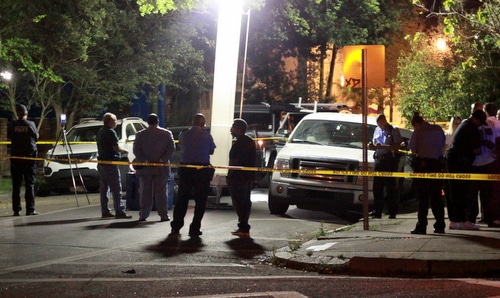 Investigators gather on Sophie Wright Place after the fatal shooting of former Saints player Will Smith. (Robert Morris, UptownMessenger.com)