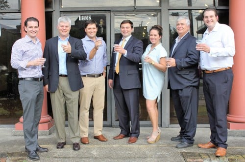 Toasting the start of renovations at Lula (from left) are co-owner Bear Caffery, contractor Nick Mills of Woodward Design Build, co-owner Jess Bourgeois, Ken Flower of Woodward Design Build, Amber Carrier of Woodward Design Build, Andrew Marshall of AllSouth Appraisal, and Layne Court of Woodward Design Build. (submitted photo) 