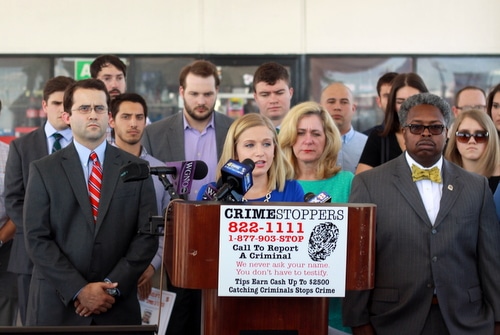 Flanked by detectives and family members, Elizabeth Fried speaks about the death of her fiancee, Thomas Rolfes. (Robert Morris, UptownMessenger.com)