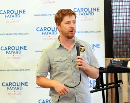 Jacob Landry, founder of Urban South Brewery, introduces Caroline Fayard at the rally. (Robert Morris, UptownMessenger.com)