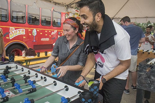 Sarah Bajor, left, and Ajay Bhoja, right, play foosball in the Classic and Vintage 3rd annual World Foosball Championship. The game was part of Freret Street Funday, a part of Tales of the Cocktail. (Zach Brien, UptownMessenger.com)