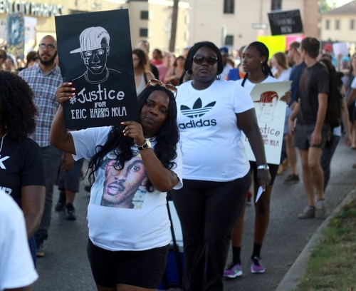 The mother of Eric Harris, who was shot to death Feb. 8 by Jefferson Parish deputies, marches with a sign demanding justice for her son following a rally in Central City on Friday. (Robert Morris, UptownMessenger.com)