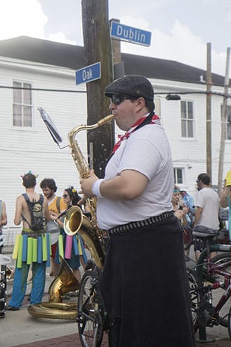 Chris Freire of the Browncoat Brass practices his saxophone before the parade rolls. The Krewe of O.A.K. celebrated the 30th anniversary of Mid Summer Mardi Gras with the theme "Get Wet". (Zach Brien, UptownMessenger.com)
