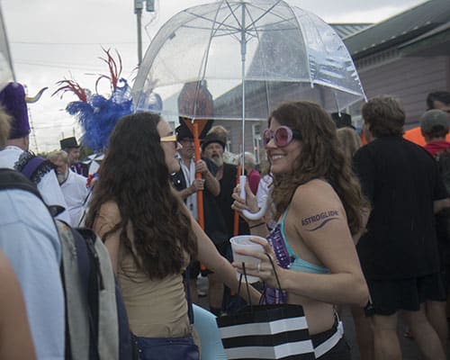 Lyric Cox, felt, and Gretchen Cook, right, chat before the start of the parade. The Krewe of O.A.K. celebrated the 30th anniversary of Mid Summer Mardi Gras with the theme "Get Wet". (Zach Brien, UptownMessenger.com)
